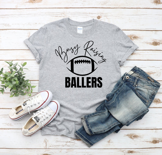 Busy Raising Ballers (Football) Unisex Tee